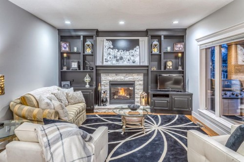 158 Gleneagles View, Cochrane, AB - Indoor Photo Showing Living Room With Fireplace