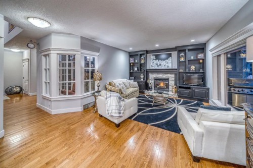 158 Gleneagles View, Cochrane, AB - Indoor Photo Showing Living Room With Fireplace