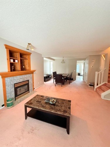 7212 Sierra Morena Boulevard Sw, Calgary, AB - Indoor Photo Showing Living Room With Fireplace