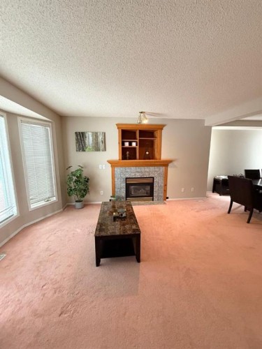 7212 Sierra Morena Boulevard Sw, Calgary, AB - Indoor Photo Showing Living Room With Fireplace