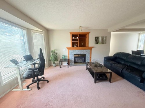 7212 Sierra Morena Boulevard Sw, Calgary, AB - Indoor Photo Showing Living Room With Fireplace