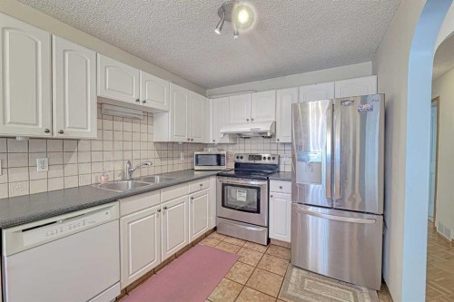 24 Shawmeadows Road Sw, Calgary, AB - Indoor Photo Showing Kitchen With Double Sink