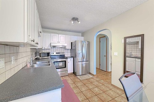 24 Shawmeadows Road Sw, Calgary, AB - Indoor Photo Showing Kitchen With Double Sink