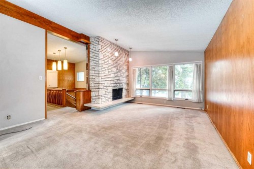 6729 Leeson Court Sw, Calgary, AB - Indoor Photo Showing Other Room With Fireplace