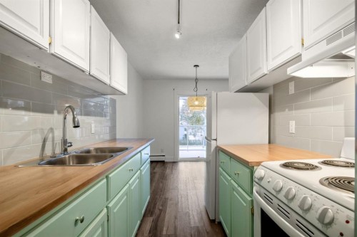 5-2319 19 Street, Nanton, AB - Indoor Photo Showing Kitchen With Double Sink