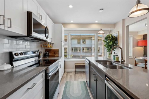 109 Coachway Lane Sw, Calgary, AB - Indoor Photo Showing Kitchen With Stainless Steel Kitchen With Double Sink With Upgraded Kitchen