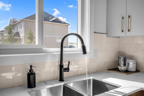 604 Clover Road, Carstairs, AB - Indoor Photo Showing Kitchen With Double Sink