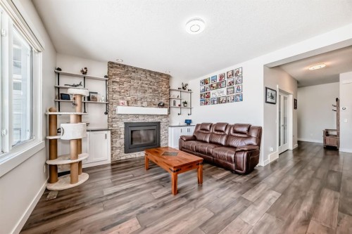 69 Sundown Grove, Cochrane, AB - Indoor Photo Showing Living Room With Fireplace
