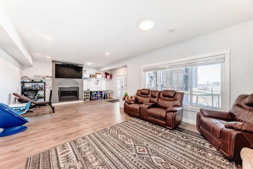 69 Sundown Grove, Cochrane, AB - Indoor Photo Showing Living Room With Fireplace