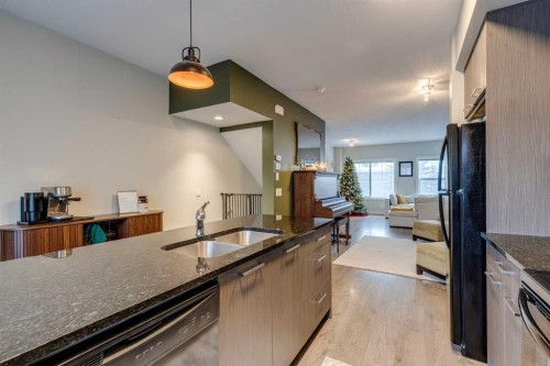 2103 Jumping Pound Common, Cochrane, AB - Indoor Photo Showing Kitchen With Double Sink