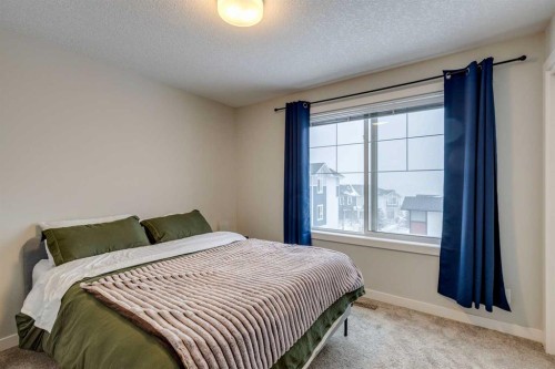 2103 Jumping Pound Common, Cochrane, AB - Indoor Photo Showing Bedroom