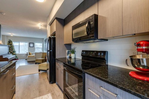 2103 Jumping Pound Common, Cochrane, AB - Indoor Photo Showing Kitchen