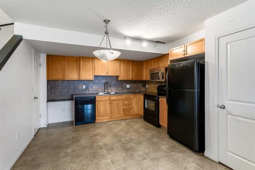 16-21 Mckenzie Towne Gate Se, Calgary, AB - Indoor Photo Showing Kitchen With Double Sink