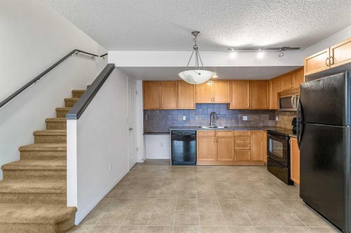 16-21 Mckenzie Towne Gate Se, Calgary, AB - Indoor Photo Showing Kitchen With Double Sink