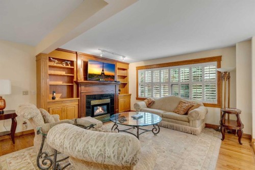 204 Paliswood Park Sw, Calgary, AB - Indoor Photo Showing Living Room With Fireplace