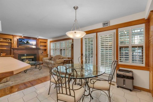 204 Paliswood Park Sw, Calgary, AB - Indoor Photo Showing Dining Room With Fireplace