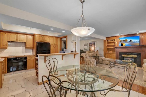 204 Paliswood Park Sw, Calgary, AB - Indoor Photo Showing Dining Room With Fireplace