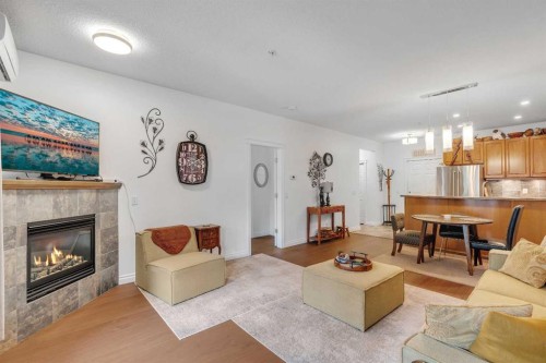 101-8 Hemlock Crescent Sw, Calgary, AB - Indoor Photo Showing Living Room With Fireplace