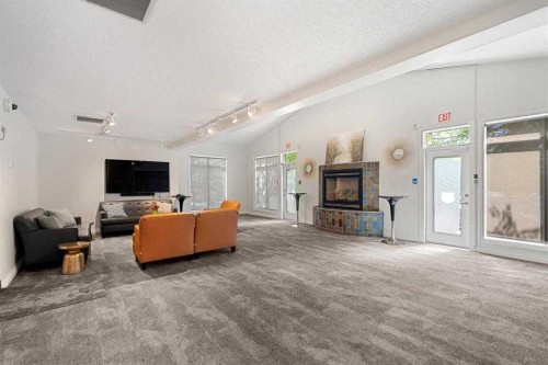 101-8 Hemlock Crescent Sw, Calgary, AB - Indoor Photo Showing Living Room With Fireplace