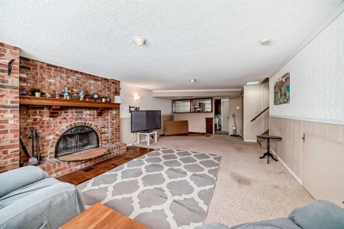 31 Fenton Road Se, Calgary, AB - Indoor Photo Showing Living Room With Fireplace