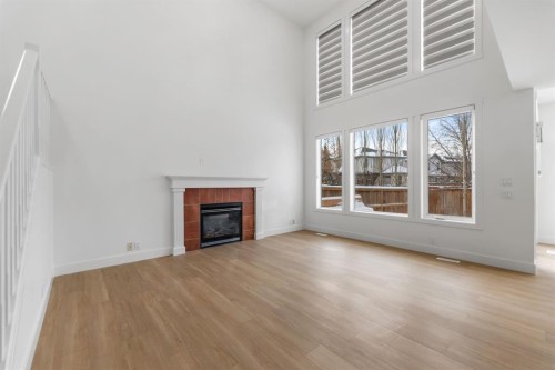 213 Tuscany  Ravine Close Nw, Calgary, AB - Indoor Photo Showing Living Room With Fireplace