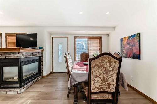 51 Everstone Boulevard Sw, Calgary, AB - Indoor Photo Showing Dining Room With Fireplace