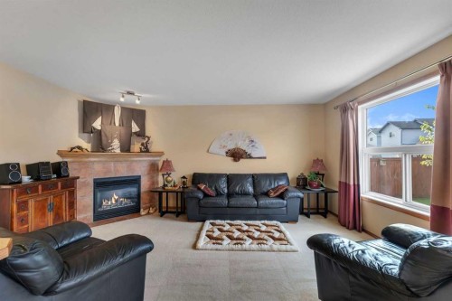 214 Saddlemont Boulevard Ne, Calgary, AB - Indoor Photo Showing Living Room With Fireplace