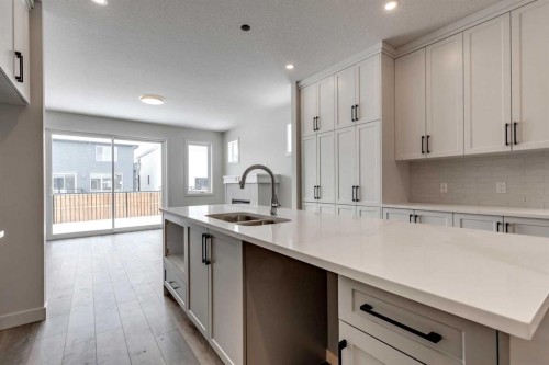 554 Rivercrest View, Cochrane, AB - Indoor Photo Showing Kitchen With Double Sink