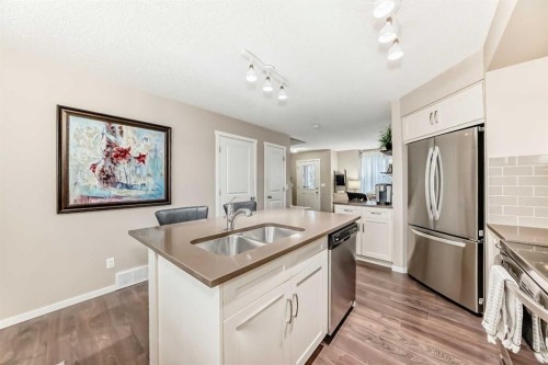 112 Sunvalley Road, Cochrane, AB - Indoor Photo Showing Kitchen With Stainless Steel Kitchen With Double Sink