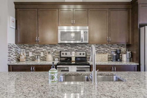 114 Cranford Bay Se, Calgary, AB - Indoor Photo Showing Kitchen With Stainless Steel Kitchen With Double Sink With Upgraded Kitchen