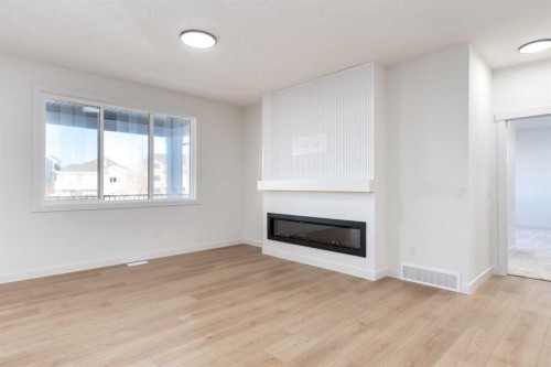 208 Monterey Bay Se, High River, AB - Indoor Photo Showing Living Room With Fireplace