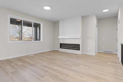 210 Monterey, High River, AB - Indoor Photo Showing Living Room With Fireplace