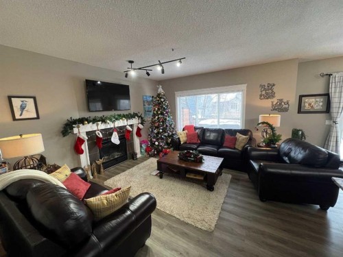 2117 Reunion Boulevard Nw, Airdrie, AB - Indoor Photo Showing Living Room With Fireplace