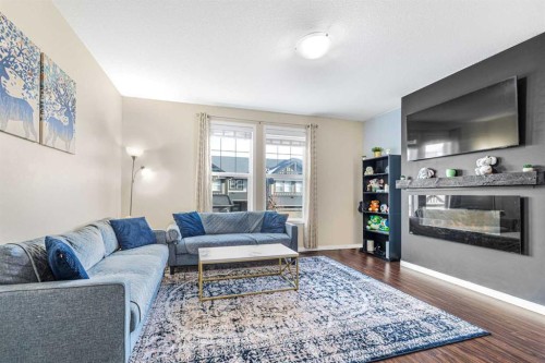 504-1086 Williamstown Boulevard, Airdrie, AB - Indoor Photo Showing Living Room With Fireplace