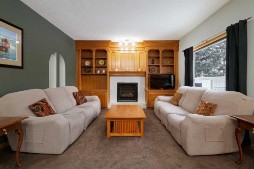 247 Mt Selkirk Close Se, Calgary, AB - Indoor Photo Showing Living Room With Fireplace