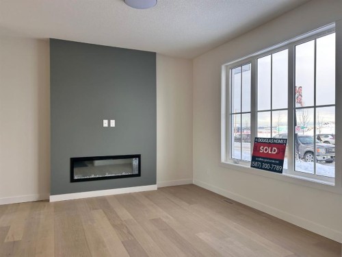 25 Sora Gate Se, Calgary, AB - Indoor Photo Showing Living Room With Fireplace