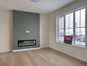 25 Sora Gate Se, Calgary, AB  - Indoor Photo Showing Living Room With Fireplace 