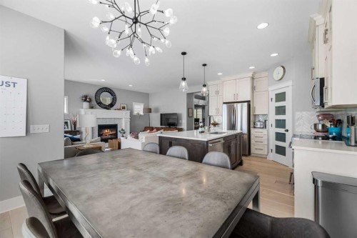 13 Royal Birch Park Nw, Calgary, AB - Indoor Photo Showing Dining Room With Fireplace