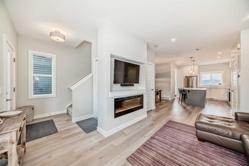 934 Cobblemore Common Sw, Airdrie, AB - Indoor Photo Showing Living Room With Fireplace
