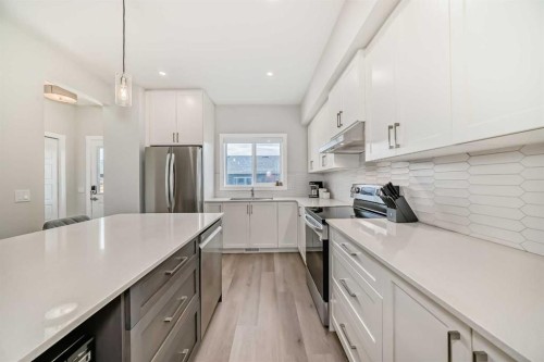 934 Cobblemore Common Sw, Airdrie, AB - Indoor Photo Showing Kitchen With Stainless Steel Kitchen With Upgraded Kitchen