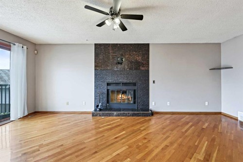 128 Ventura Way Ne, Calgary, AB - Indoor Photo Showing Living Room With Fireplace
