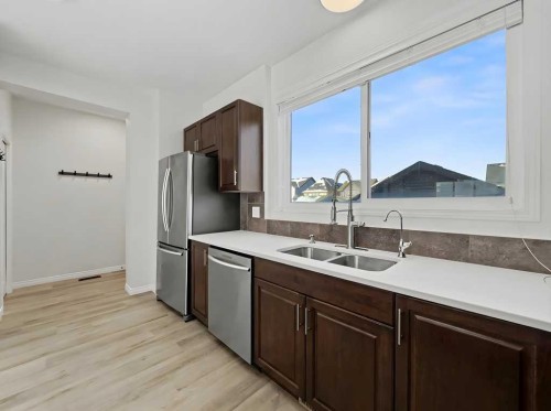 104 Masters Link Se, Calgary, AB - Indoor Photo Showing Kitchen With Stainless Steel Kitchen With Double Sink