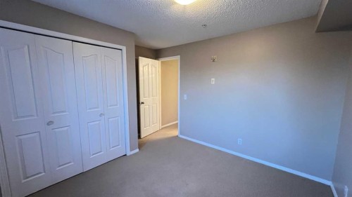 1208-12 Cimarron Common, Okotoks, AB - Indoor Photo Showing Other Room
