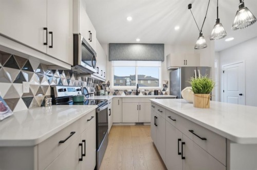 114 Wolf Creek Rise Se, Calgary, AB - Indoor Photo Showing Kitchen With Double Sink With Upgraded Kitchen