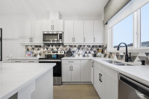 114 Wolf Creek Rise Se, Calgary, AB - Indoor Photo Showing Kitchen With Double Sink