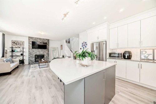257 Carrington Way Nw, Calgary, AB - Indoor Photo Showing Kitchen With Fireplace With Upgraded Kitchen