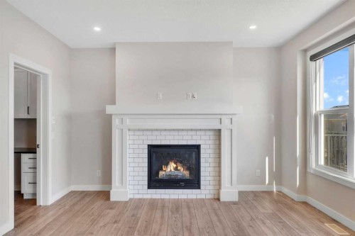 34 Sage Bluff Heights Nw, Calgary, AB - Indoor Photo Showing Living Room With Fireplace