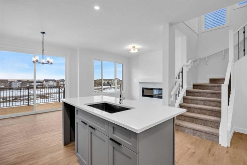 739 Langley Terrace Se, Airdrie, AB - Indoor Photo Showing Kitchen With Fireplace