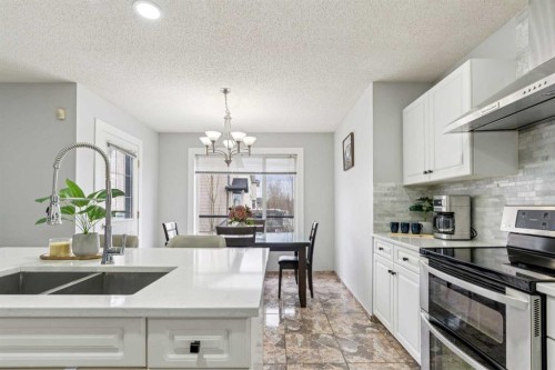 206 Bridlecreek Green Sw, Calgary, AB - Indoor Photo Showing Kitchen With Double Sink With Upgraded Kitchen