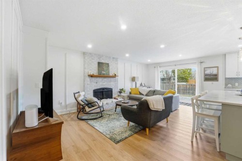 60 Sunmount Close Se, Calgary, AB - Indoor Photo Showing Other Room With Fireplace